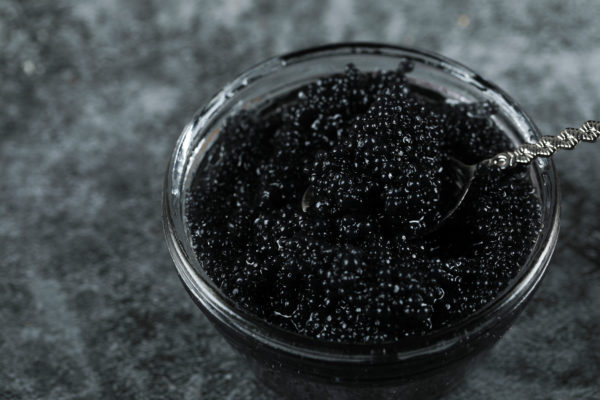 Black caviar in a glass jar, top view
