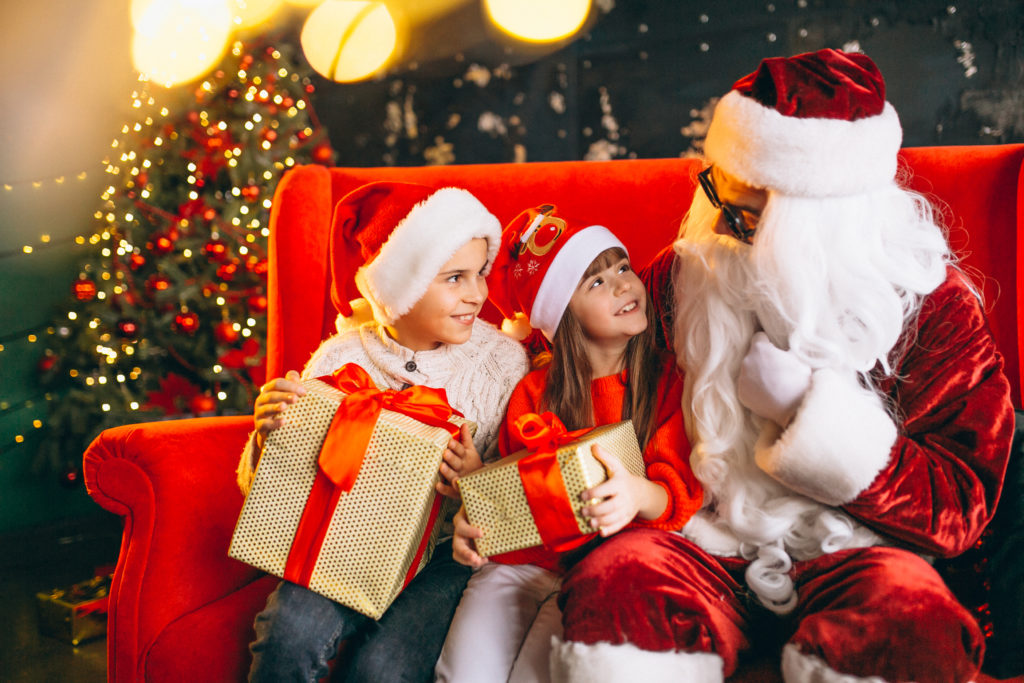 Group Kids Sitting With Santa Presents Christmas Eve 1024x683
