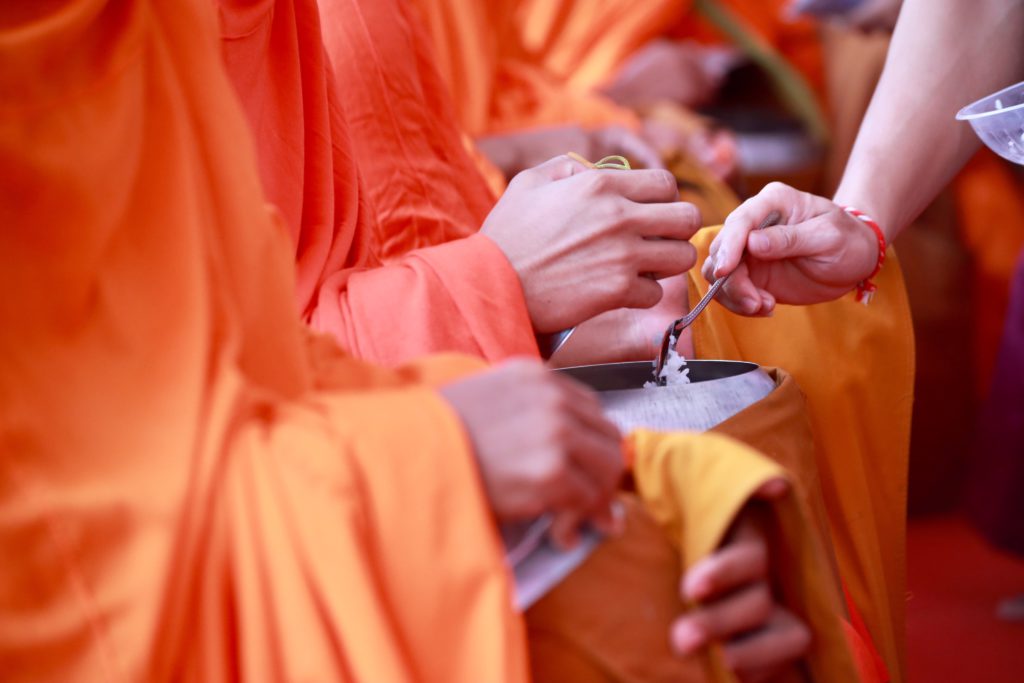 Cropped Image Woman Giving Food Monks