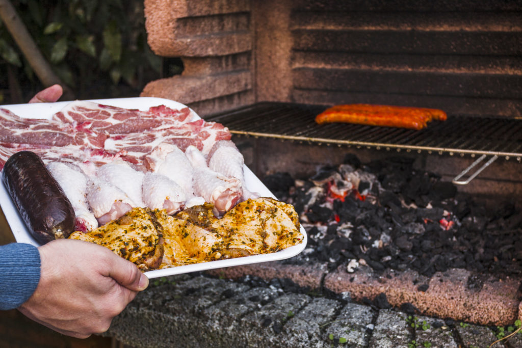 Human Hand Holding Tray Raw Meat